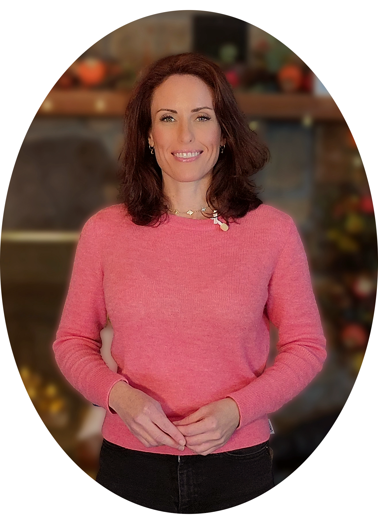 Mary-Kate Seward, founder of Beacon Ranch Studio, smiling in a blue patterned top against a background of green foliage and pink flowers